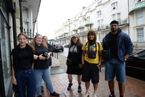 A group of young people in the street ready to go and take photographs