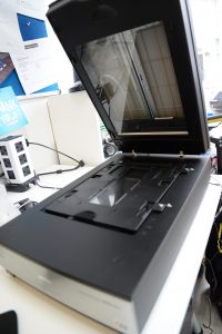A digital film scanner open to show the glass top inside